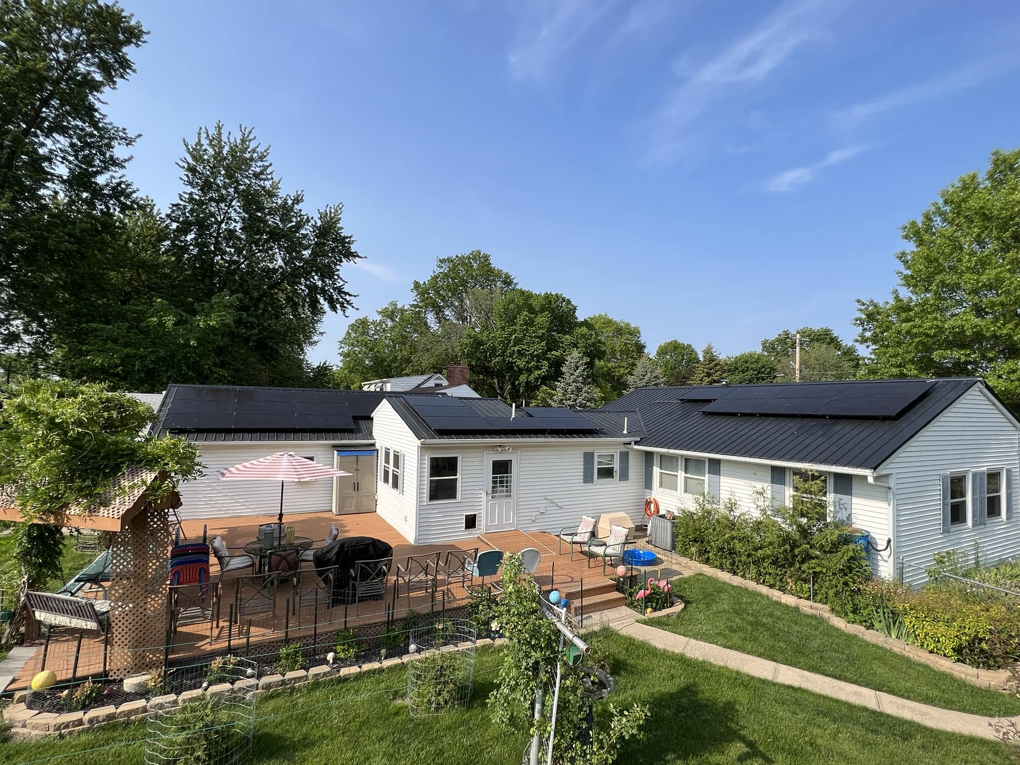 Photograph of a home solar installation in Iowa by True Solar, showcasing a neatly arranged array of solar panels on the roof, capturing the bright sunshine and harnessing clean energy.